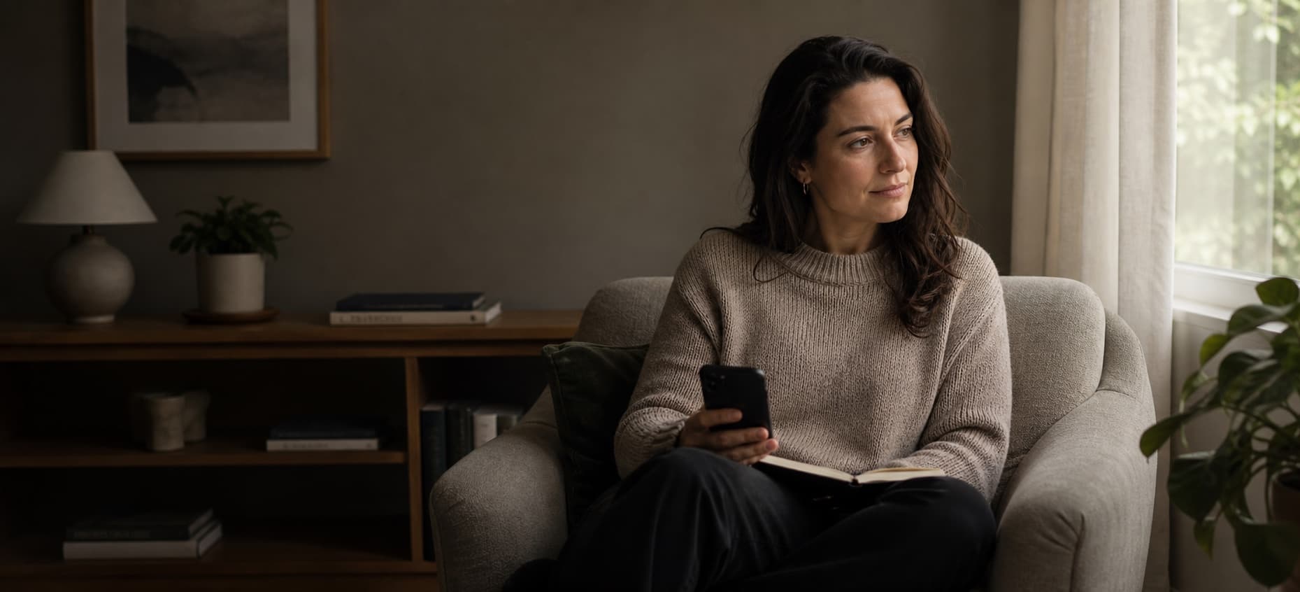 A person with a phone and notebook preparing for a first conversation